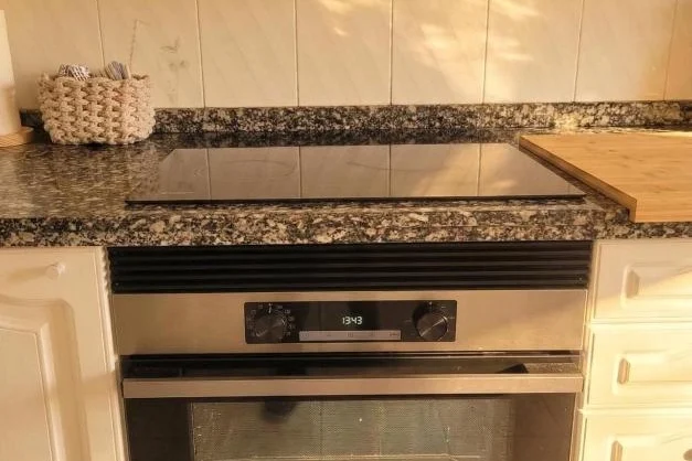 Kitchen with oven and ceramic hob